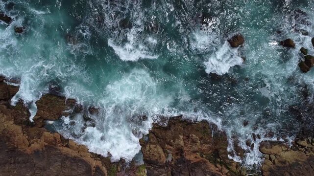 Turquoise Waves Crashing on Rocky Coastline &ndash; Garopaba, Brazil aerial drone shot