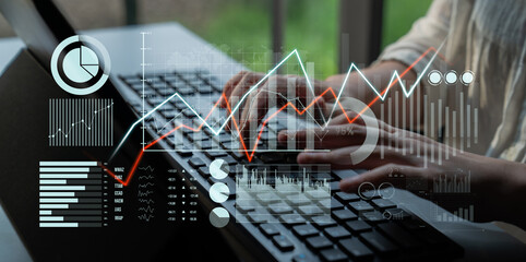 A business professional engages in data analysis on a laptop, highlighted by digital graphs and...