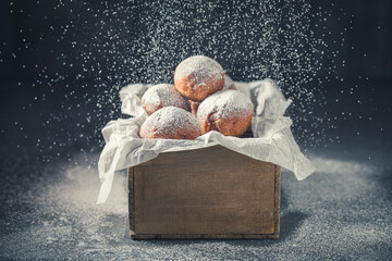 Fresh and sweet mini doughnuts deep frying in oil.