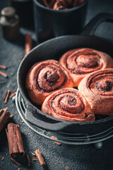 Hot cinnamon buns with cocoa and sugar. Scandinavian dessert.