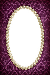Oval frame of pearls on a background of purple pattern close-up