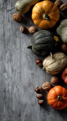 Assorted pumpkins gourds nuts and apple on rustic wood