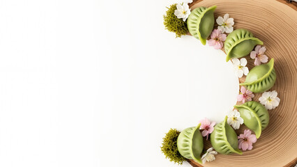 Artistic floral crescent featuring Qingming festival background with green dumplings on wood, spring nature design with copy space