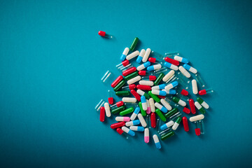 Colorful pills on a blue table