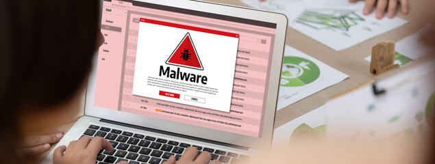 Cyber attacking concept. Malware alert showing on computer screen display scam and threat detection on computer system or online server to be removed brisk.