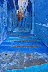 Narrow, stepped, pedestrian passageway linking the different levels of the medina, painted as is customary in shades of blue. Chefchaouen-Morocco-036