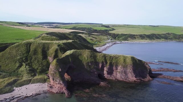 Natural arch in Aberdour beach area in Scotland.
