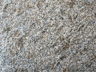 Close up view showing speckled gray and brown natural granite stone texture