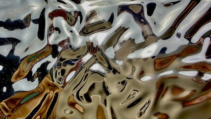 abstract molten liquid metal swirl in golden silver tones with fluid waves bubbles glossy reflections futuristic texture for wallpaper banner.