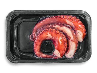 Pre-cooked octopus tentacles vacuum-packed in black plastic trays isolated on white with clipping path included