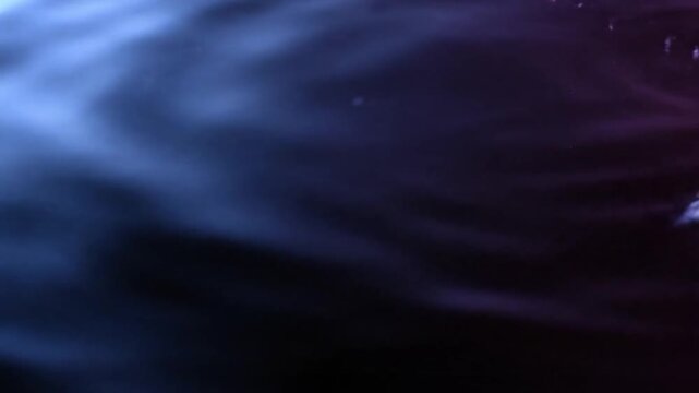 Swirling Dark Blue Water Vortex with Ripples and Reflections in Dark Atmosphere