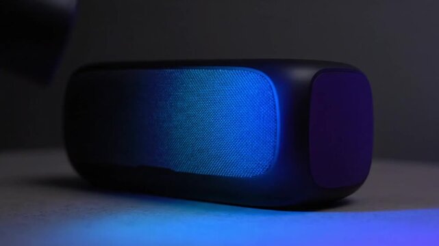 Modern Bluetooth Speaker with Colorful L E D Lighting on Table in Dimly Lit Room