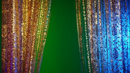 Elegant shimmering curtain backdrop with gold, blue, and green illumination for special events