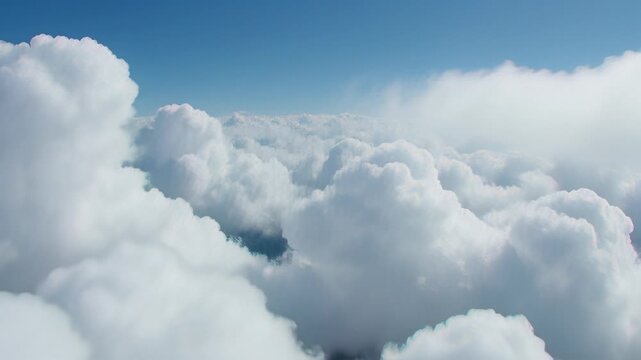 Cinematic flight through fluffy white cumulus clouds in a bright blue sky, creating a dreamy aerial background for travel and aviation projects