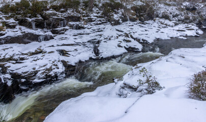 Cascading water in the River Dee in snow and ice
