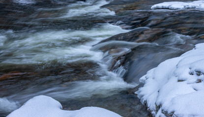 Cascading water in the River Dee in snow and ice © Sarah