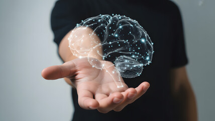 Person holding glowing brain with futuristic neural network