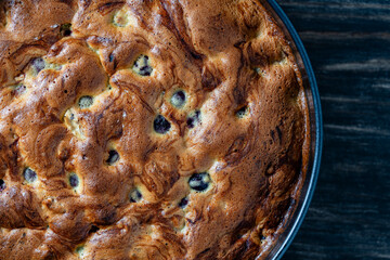 Cherry sponge pie on wooden table, top view, closeup. Delicious summer homemade American cake with cherries. Sweet dessert