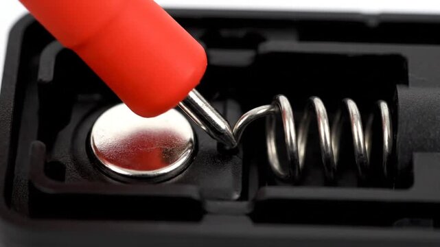 Red Probe Testing Silver Battery Terminal Spring Contact in Black Plastic Case for Electrical Conductivity and Power