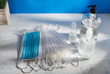 Face masks and hand sanitizer hygiene concept with clean minimal indoor still life