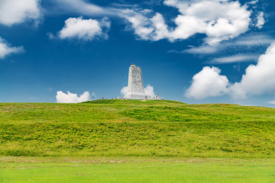 Historic Wright Brothers Memorial rising above green hill in North Carolina