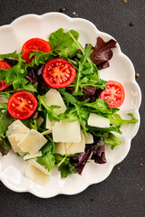 Parmesan cheese vegetable salad tomato, arugula, green leaf lettuce healthy food main course ingredient appetizer fresh tasty gourmet food background food top view copy space vegetarian food