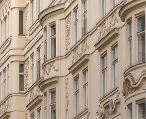 Fototapeta premium A row of facades of historic residential buildings in Vienna with smooth lines and classical architecture