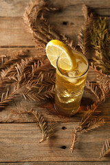 Green Tea With Ice and Lemon Served on a Wooden Table With Leaves Around