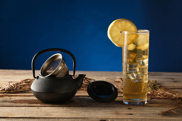 Enjoying Green Tea With Ice on a Wooden Table Under Soft Lighting