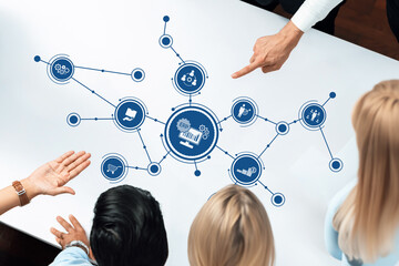 A diverse team collaborates in a modern workspace, using digital tools for data analysis and communication, highlighting teamwork and innovative business strategies. Amity