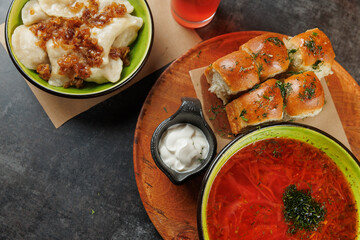 Delicious spread of Ukrainian and Eastern European dishes served on a wooden platter during a meal...