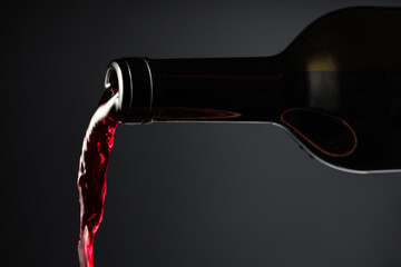 Fototapeta premium Red wine pours out of the bottle.