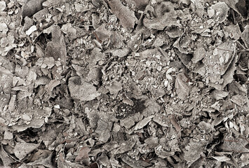 Charred paper ashes as background, top view. Cinder. Burned paper scraps.