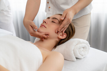 Caucasian woman enjoying relaxing anti-stress head massage and pampering facial beauty skin...