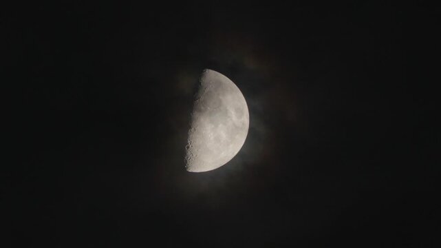 Moon phase in the dark night sky and flying translucent clouds