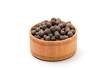 A bowl of black peppercorns on a white background