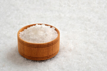Salt crystals in a wooden bowl close-up