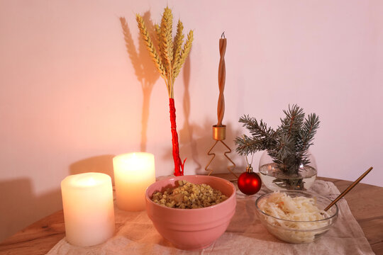 Didukh made of wheat ears kutia candles and sauerkraut in a bowl traditional Christmas composition.