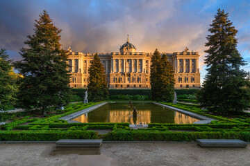 Fototapeta premium Sunset view of Royal Palace of Madrid and Sabatini Gardens in Madrid, Spain. Architecture and landmark of Madrid.