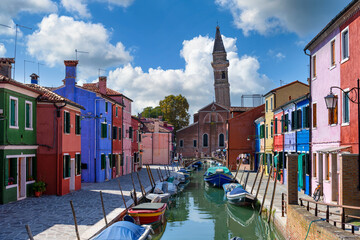 Street with colorful buildings and canal in Burano island, Venice, Italy. Architecture and landmarks of Venice, Venice postcard