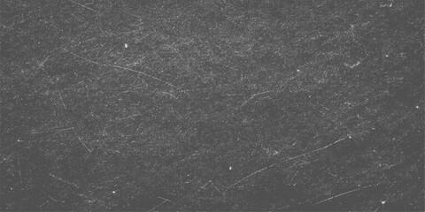 A dark and textured closeup of grey asphalt shows a rough stone surface where raindrops create an abstract grunge pattern on the black street road