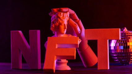 Conceptual Still Life with NFT Letters Classical Bust and Wooden Hand under Neon Lights