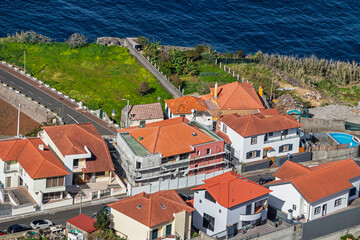 White houses with orange clay tile roofs. Building renovation and restoration