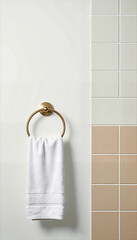 White towel hanging on gold holder against modern tiled wall  