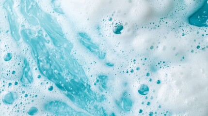 Soap foam rests on blue water color creating a textured surface with bubbles and frothy patterns that suggest movement and fluidity in a playful manner