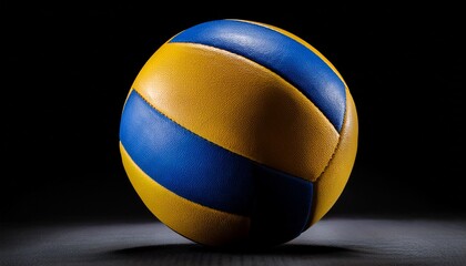 Fototapeta premium close up high quality image of a blue and yellow volleyball isolated on black background