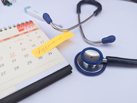 Medical doctor appointment concept with stethoscope and calendar on white background