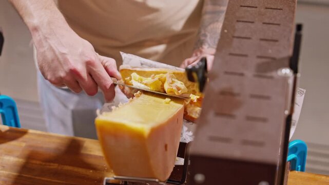 Traditional cheese raclette. Food culture in France. A warm and inviting raclette stand melting cheese over fresh bread, filling the Christmas market with cozy aromas and festive winter charm