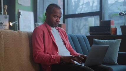 Individual working diligently at home with laptop, Person engaged in work inside cozy home environment