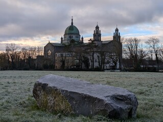 Galway Cathedral Irish Landmark Architecture with Green Dome and Stone Towers Under Blue Sky and Frosty Morning Grass in Ireland